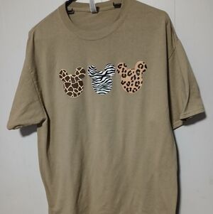 Jerzees ladies green t-shirt with animal head prints on front. Size large
